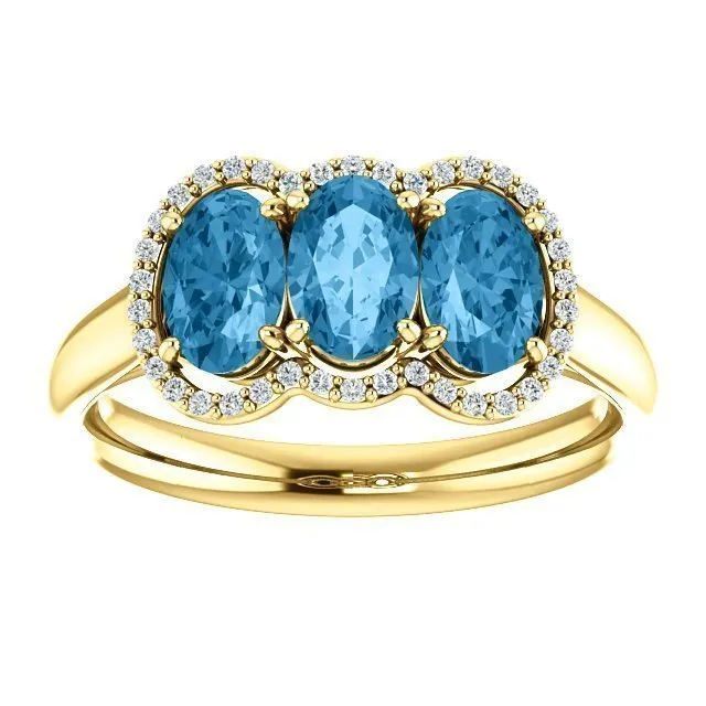 14KT GOLD 1.74 CTW BLUE TOPAZ & .10 CTW DIAMOND 3 STONE OVAL HALO RING