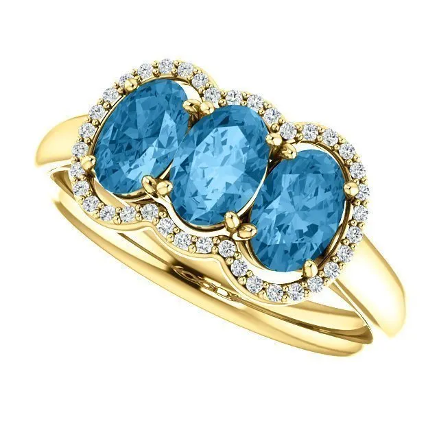 14KT GOLD 1.74 CTW BLUE TOPAZ & .10 CTW DIAMOND 3 STONE OVAL HALO RING