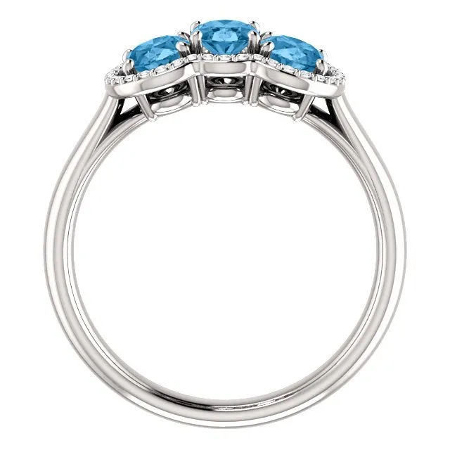 14KT GOLD 1.74 CTW BLUE TOPAZ & .10 CTW DIAMOND 3 STONE OVAL HALO RING