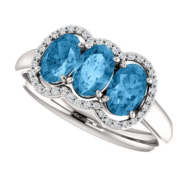 14KT GOLD 1.74 CTW BLUE TOPAZ & .10 CTW DIAMOND 3 STONE OVAL HALO RING