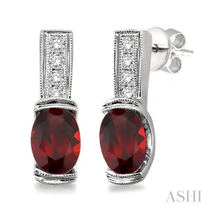 7x5 mm Oval Cut Garnet and 1/50 Ctw Single Cut Diamond Earrings in Sterling Silver