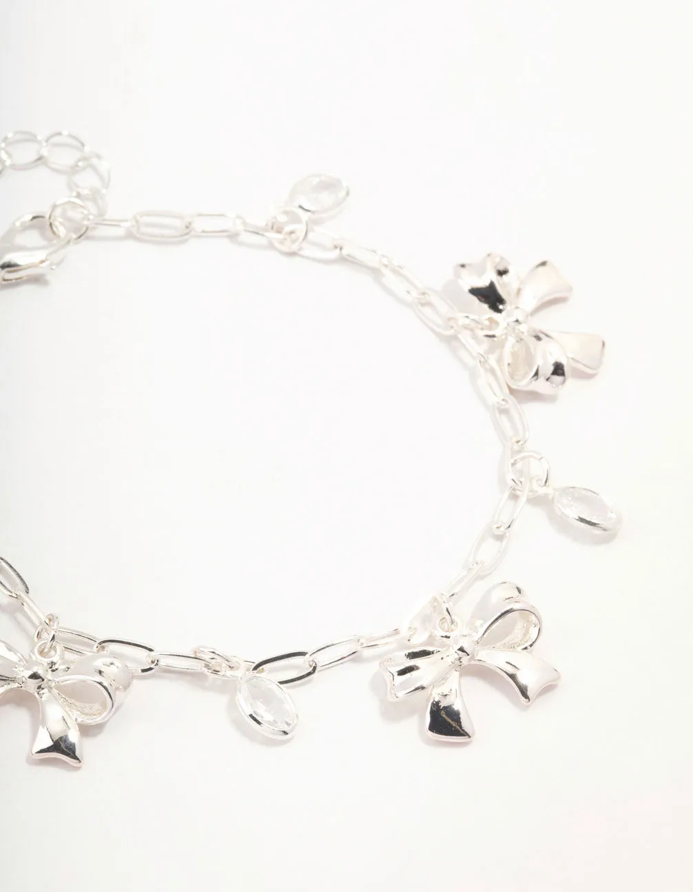 Silver Plated Alternating Cubic Zirconia & Bow Charm Bracelet